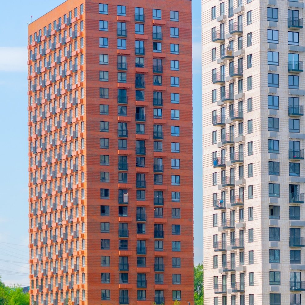 The beautiful exterior of modern skyscrapers against a blue cloudy sky during daytime
